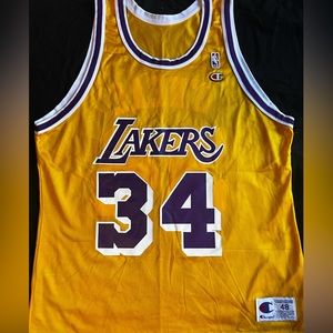 Brand new Lakers Shaquille O’Neal jersey, size 48.  Made by Champion.
